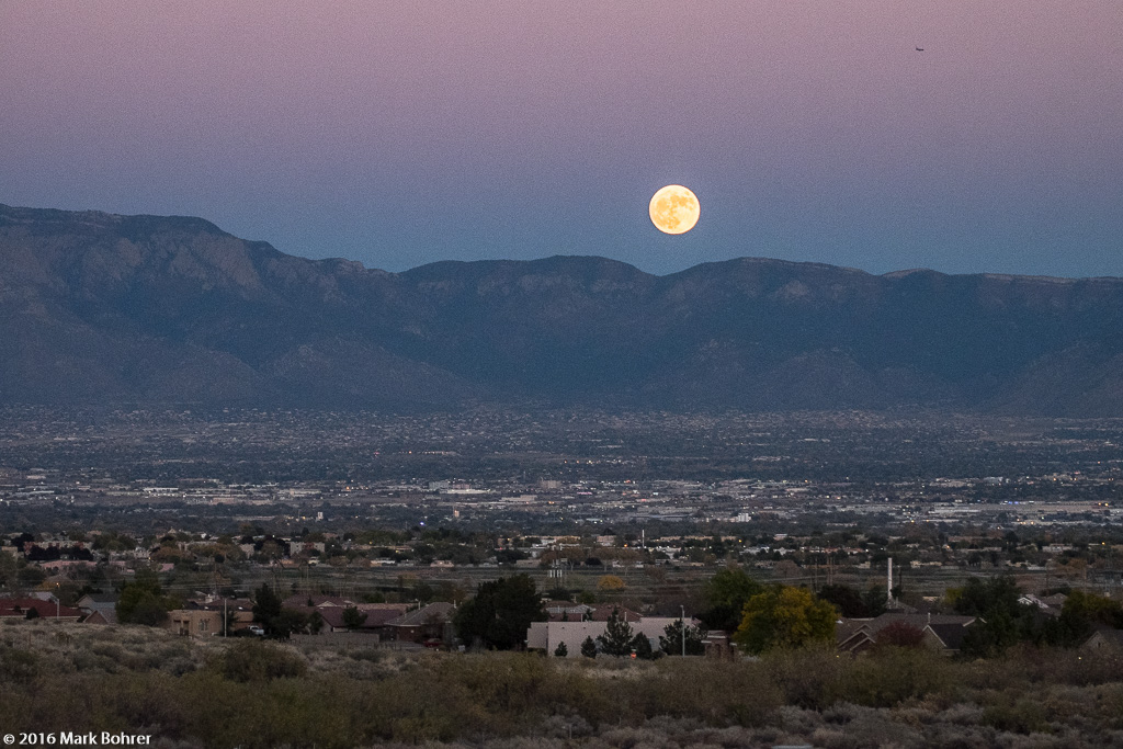Rising supermoon and Sandia Mountains