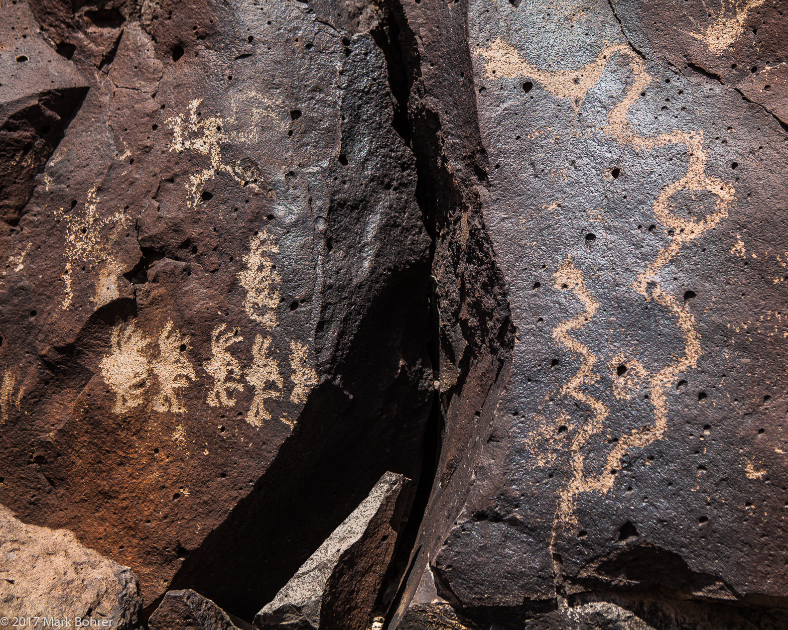 Kokopellis and snakes - La Cieneguilla Petroglyph Site