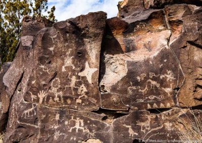 Toothy open-mouthed war god at center right - star kachina at center left